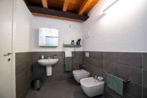 a bathroom with a sink and a toilet at Maison Selva - Palazzo Cervi Duplex Superior in Salò +30 photos