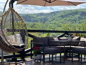 a porch with a hammock and a table and chairs at A Green Nest in Suceava