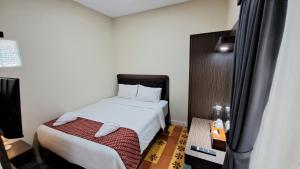 Postel nebo postele na pokoji v ubytování Yuwono Hotel & Villa Malioboro