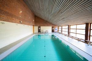 a large swimming pool in a large building at Bymose Hegn Hotel & Kursuscenter in Helsinge