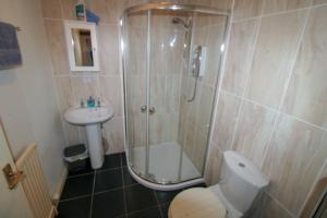 a bathroom with a shower and a toilet and a sink at Emily's Apartment, Ireby in Ireby +21 photos