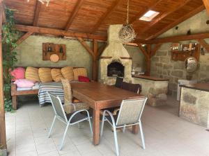 a dining room with a table and a fireplace at Apartmán 2 in Česká Lípa