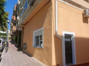 a building with a window on the side of a street at Paseo de la rambla A in Valdemoro