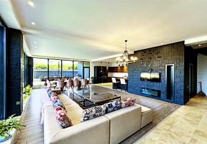a living room with a couch and a dining room at Qafqaz Resort loft Style in Gabala