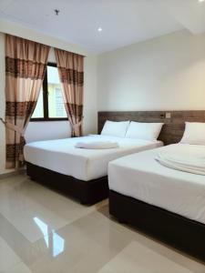 Postel nebo postele na pokoji v ubytování Hotel Sri Sutra PJ 222
