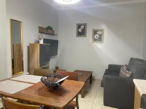 a living room with a table and a couch at Vasilakis Apartments 3 in Chios