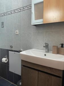 a bathroom with a white sink and a mirror at Vasilakis Apartments 3 in Chios +14 photos