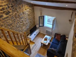 an overhead view of a living room with a stone wall at Gite cap de biou in Penne
