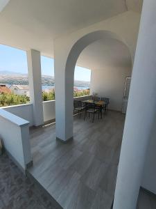 a living room with a table and a view of the ocean at Apartments Višnja in Pag