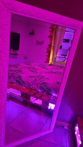 a pink room with a bed with a mirror at Les dessous du Garlaban in Roquevaire