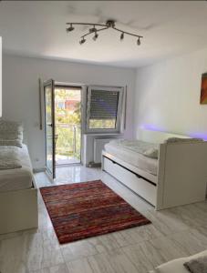 a bedroom with two beds and a rug at Gemütliche Wohnung im Herzen von Heidelberg in Heidelberg