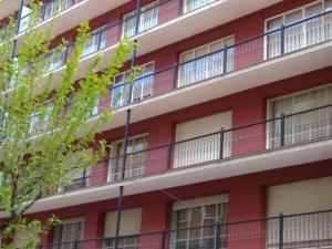 a red building with balconies on the side of it at Lar Atlántica in Vigo