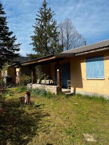 a house with a blue window on the side of it at Petit Chalet De Montagne in Thorame-Basse +2 photos