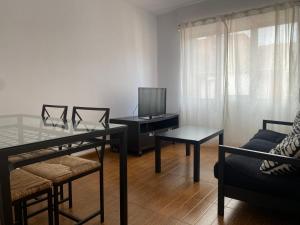 a living room with a table and a tv at Apartamento Asturiano en Pravia in Pravia
