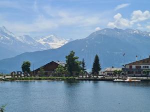 a large body of water with mountains in the background at Appartement proche remontées refait à neuf in Crans-Montana