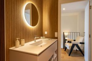a bathroom with a sink and a mirror at Valras-Loc Panarea Duplex avec vue mer, spa in Valras-Plage