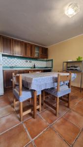 eine Küche mit einem Tisch und 2 Stühlen in der Unterkunft Villa Dei Santi, Taverna in Santa Maria di Castellabate