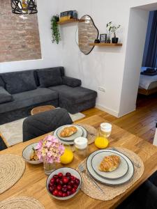 a dining room table with plates of food on it at MMA's Apartment - 1 min de Târgul de Crăciun Sibiu in Sibiu