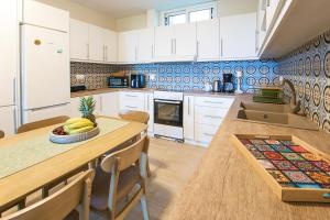 a kitchen with white cabinets and a table with bananas on it at Ilios house in Achladies