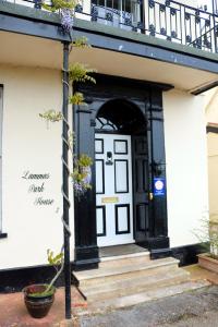 a black and white front door of a building at Lammas Park House in Dawlish