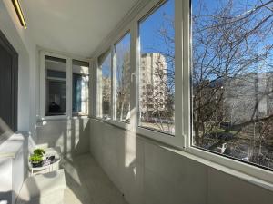 a room with windows with a view of a building at Sea & Stay in Constanţa