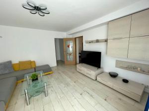 a living room with a couch and a flat screen tv at Sea & Stay in Constanţa