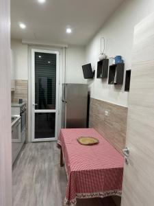 a small kitchen with a red table in a room at Cataleia in Biella