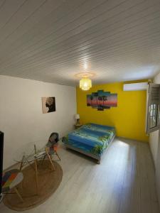 a room with a bed and a table in it at Colibri in Fort-de-France