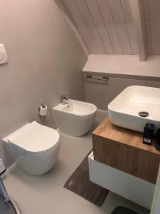 a bathroom with a white toilet and a sink at Suite Panoramic Attico con Jacuzzi Privata in Terni +48 photos