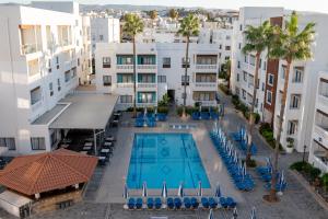 an overhead view of a swimming pool in a building at Kefalos Damon Hotel Apartments in Paphos