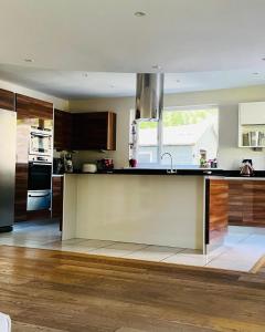 a kitchen with a sink and a counter top at 4-Bed Seaside Dream House - Sleeps 8 & Parking in Dundee