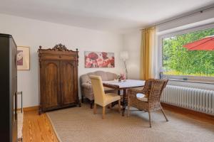a living room with a table and chairs and a window at Haus Helene Clausen in Waldhusen