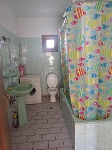 a bathroom with a toilet and a shower curtain at LA.KI House in Kavala +51 photos