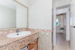 a bathroom with a sink and a mirror at Apartamento Biniforcat in Cala en Forcat +14 photos