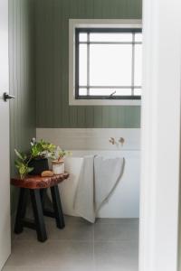a bathroom with a bath tub and a window at The Barn - On Cockatoo Lane in Sandy Creek