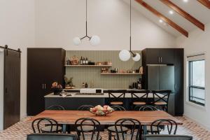 a kitchen with a table and chairs in a room at The Barn - On Cockatoo Lane in Sandy Creek