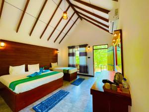 Letto o letti in una camera di Sungreen Cottage Sigiriya