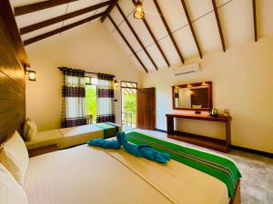 Letto o letti in una camera di Sungreen Cottage Sigiriya