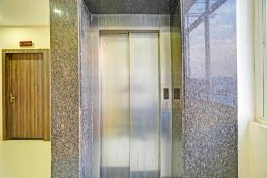 a elevator in a building with a tile wall at FabHotel Paras Palace - Bairagarh , Near Sant Hirdaram Nagar railway station in Bhopal +22 photos