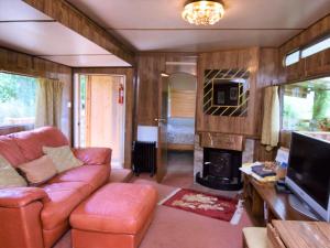 a living room with a couch and a fireplace at 1 Bed in Bodiam 51574 in Bodiam