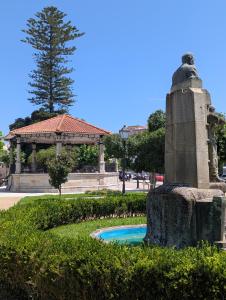 a fountain in a park with a gazebo at A Casiña Laranxa in Cangas de Morrazo +7 photos