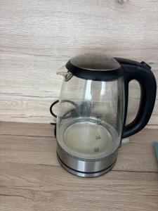 a tea kettle sitting on top of a table at Apartman Orlí hnízdo in Liberec