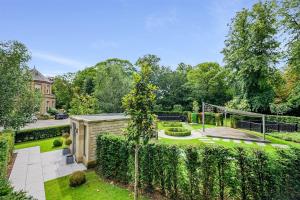 an exterior view of a garden with a fence at Luxurious subterranean mansion - 3 spectacular bedrooms in Altrincham