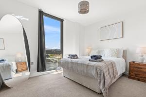 a bedroom with a bed and a large window at York Penthouse with Hot Tub & View of Minister in York