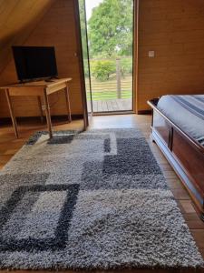 a bedroom with a bed and a desk and a rug at L'atelier in La Rochefoulques