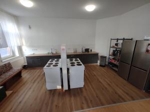 a kitchen with a stove and refrigerator in a room at Agardy,s Landgasthof in Holle