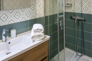 a bathroom with a sink and a shower at Ilios house in Achladies +25 photos