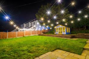 a yard lit up at night with lights at Mochdre Holiday Cottages in Mochdre