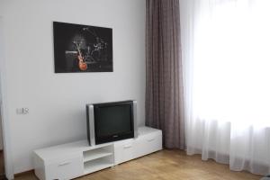 a television sitting on a white cabinet in a room at Apartment For Guests with Soul in Vinnytsya