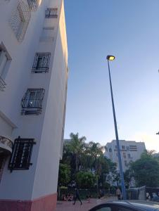 a street light next to a white building at Logement tout confort, équipé ! in Casablanca